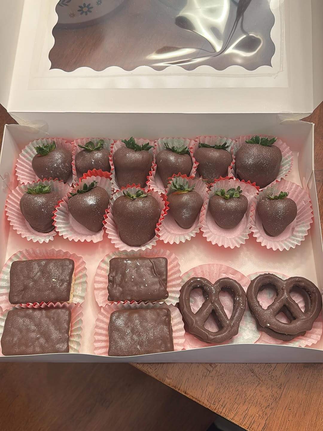 Large gift box of twelve dark chocolate strawberries, three Rice Krispie bars, and two pretzels, all with iridescent purple shimmer glitter dust.