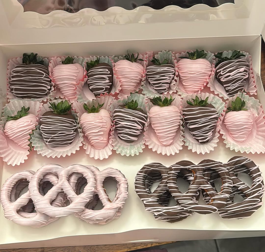 Valentine's mixed gift box with fourteen pink and dark chocolate strawberries and six matching pretzels, all with white drizzle accents.