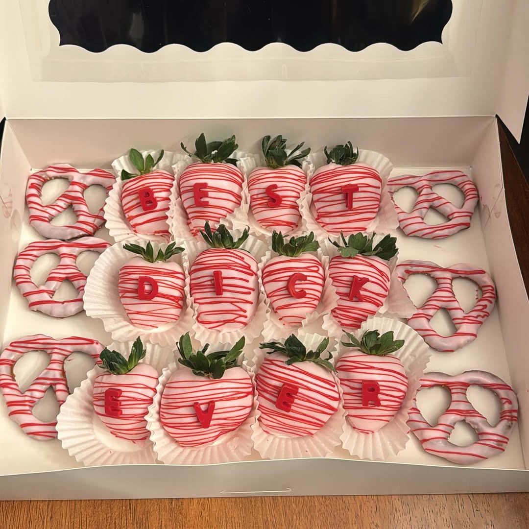 Novelty Valentine's box of white chocolate strawberries and pretzels with red drizzle and bold red fondant letters spelling a humorous adult message.